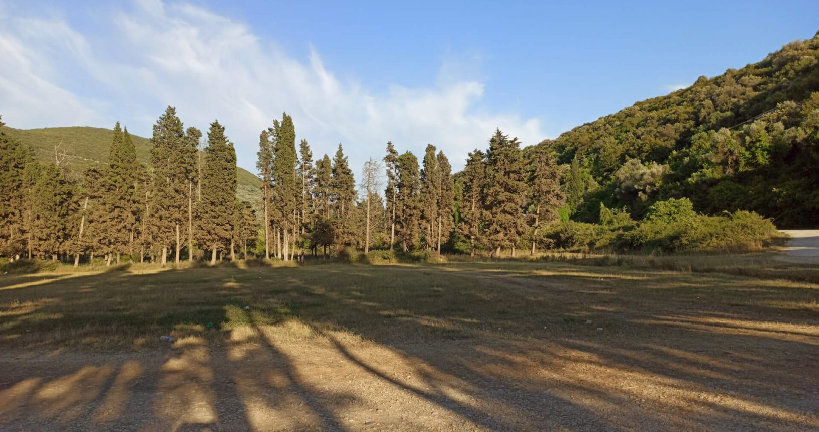 Forest surrounds big parking at Valdanos beach