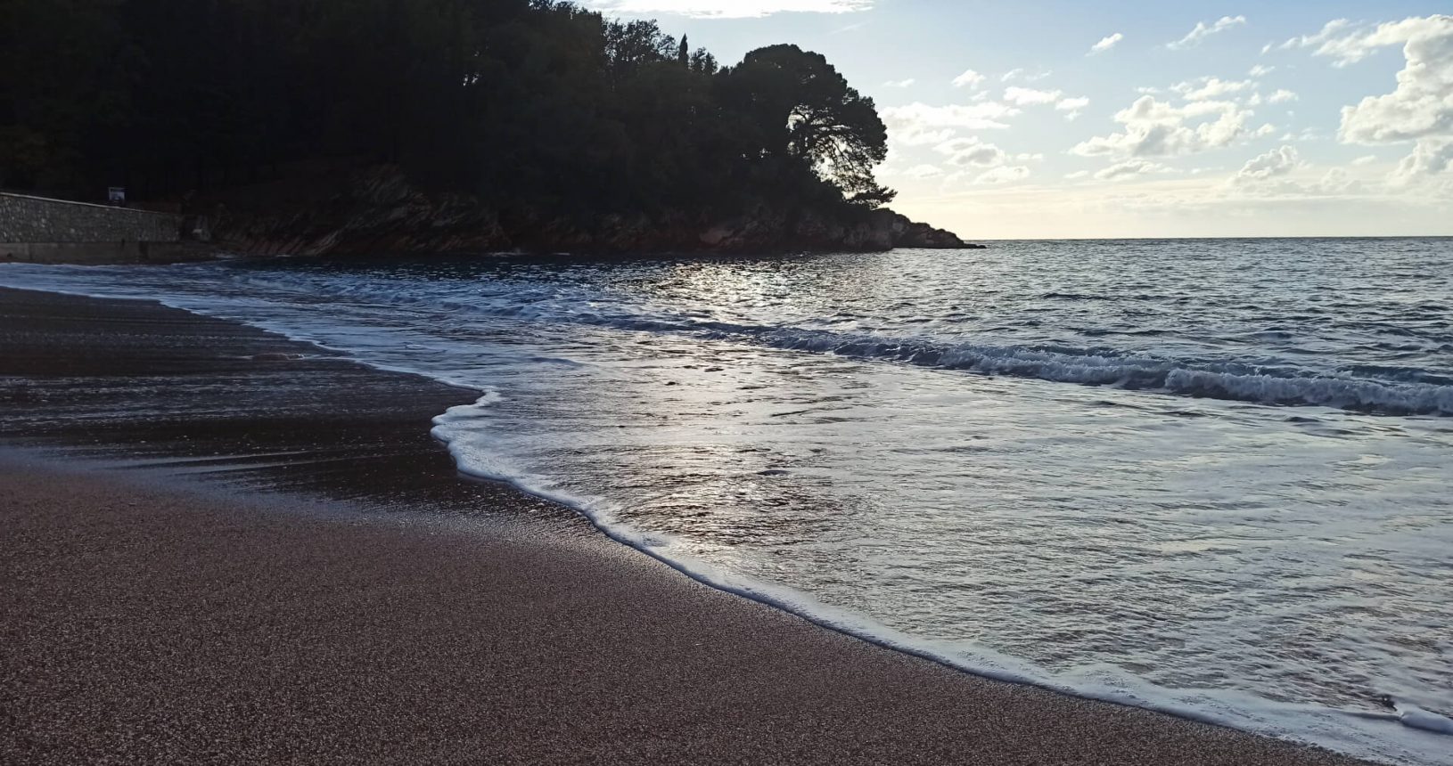Peaceful Milocer beach. Red pebble