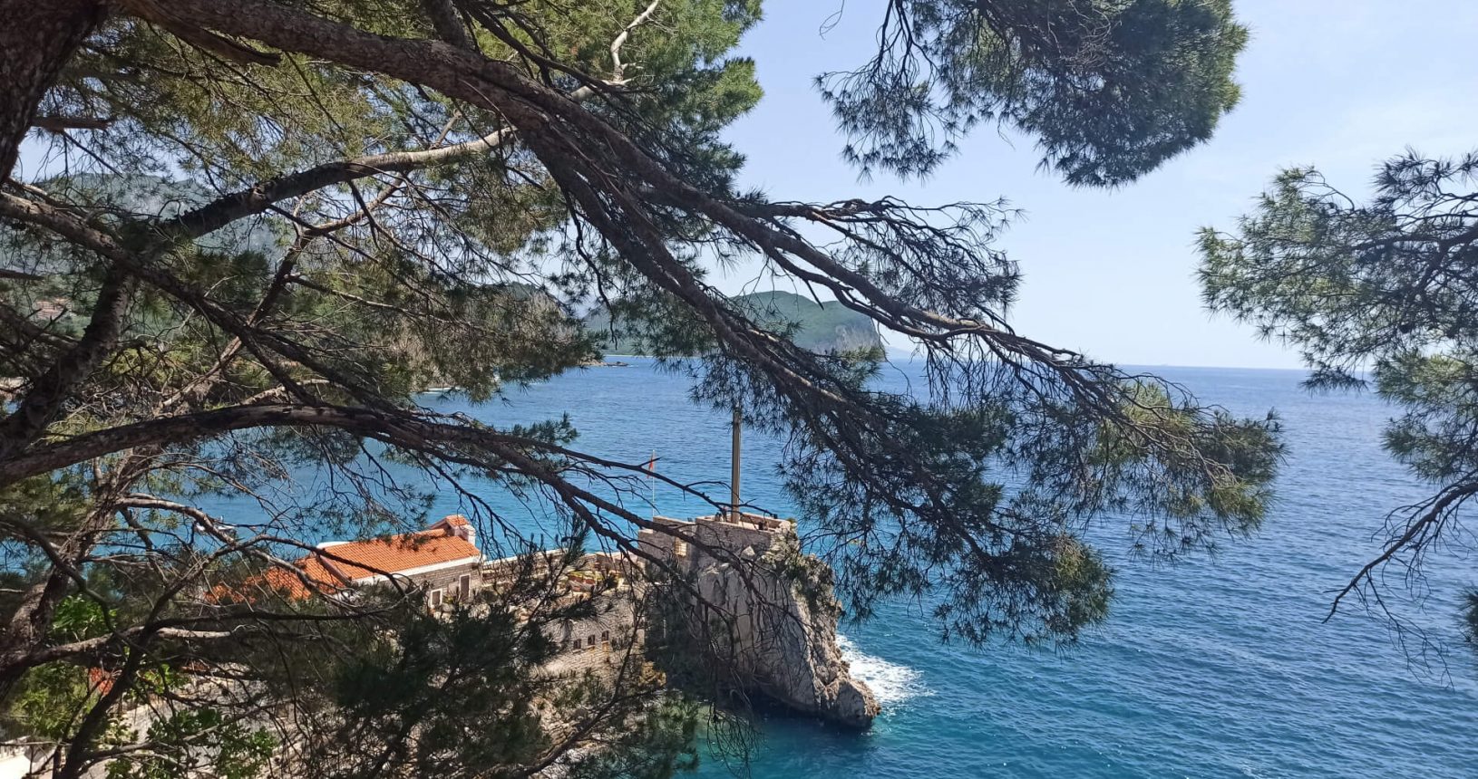 Walking trail Petrovac Rezevici from the trees in the forest. Fortress view