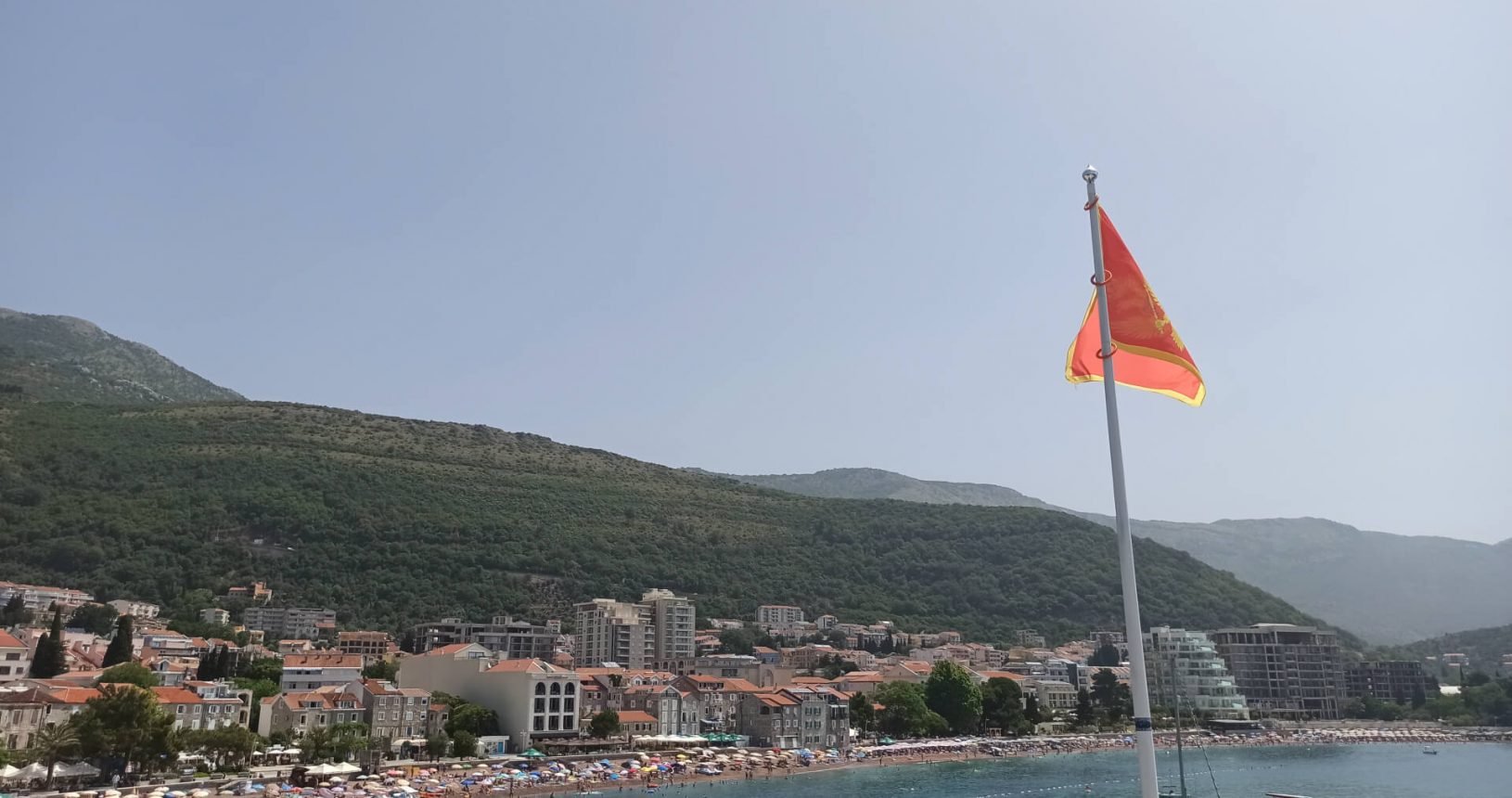 Petrovac Castle with flag and beach view