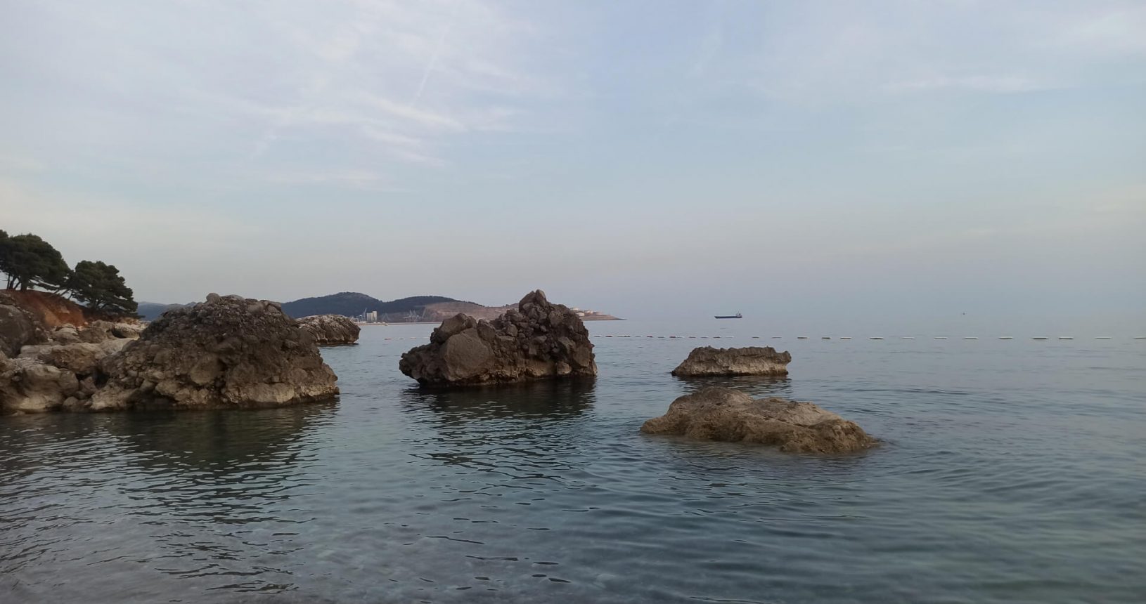 Transparent sea and stones wild beach