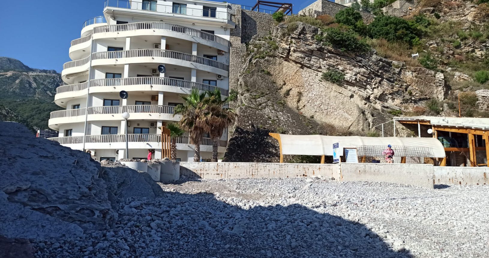 Rafailovici rocky beach cafe and buildings