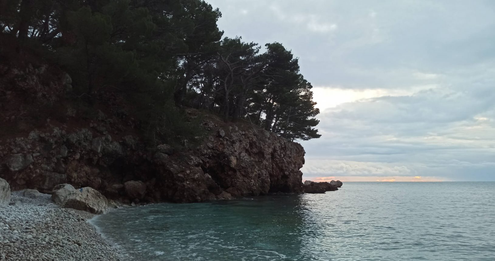 lFKK Sutomore Beach surrounded by rocks and trees