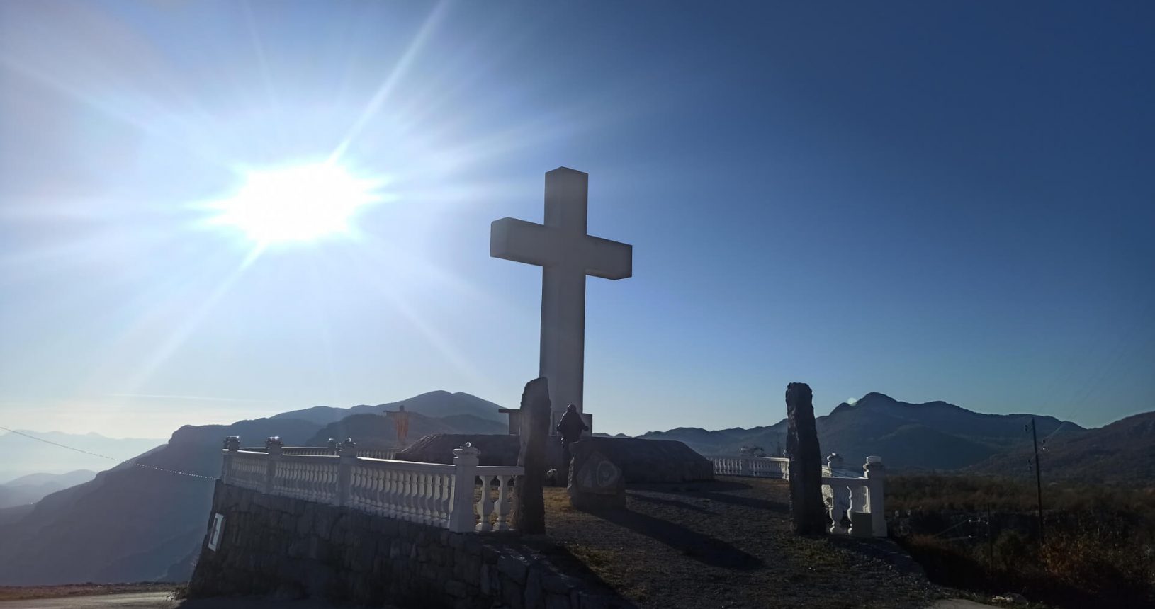 Viewpoint with big cross and Jesus under the sunlight