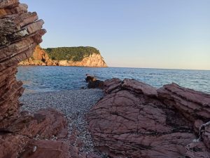 Lovely beach from behind red rocks Crvena Glavica Beach
