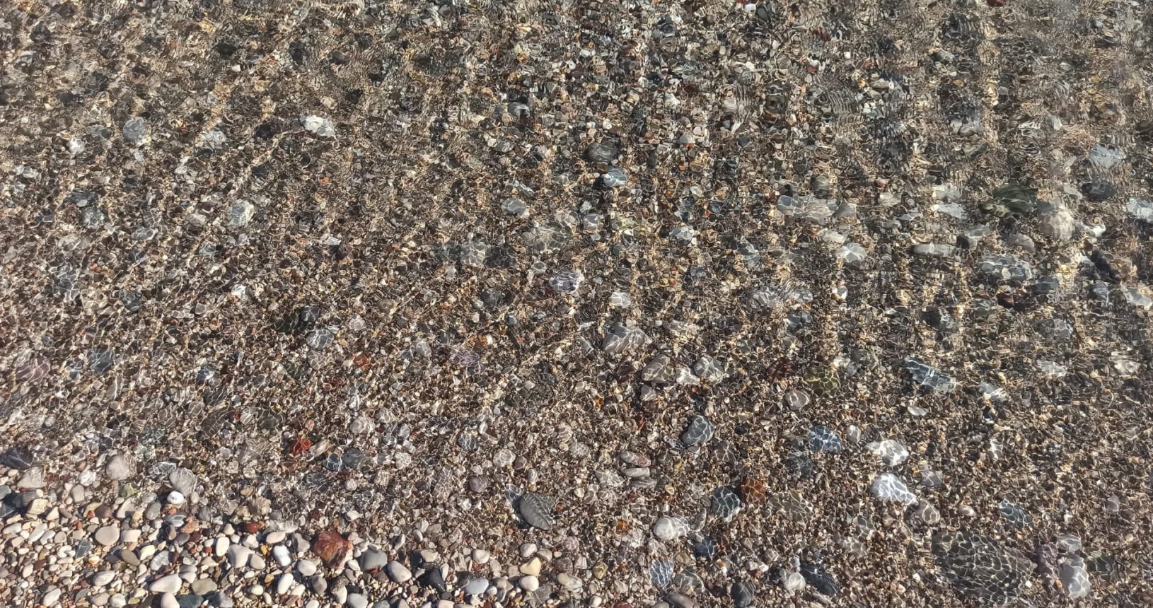 Transparent sea and stones at Strbina Beach