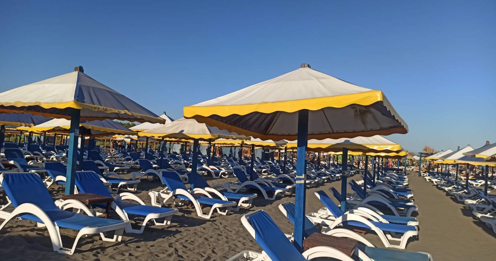 Yellow blue furniture at Toni Grill Beach